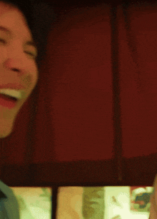 a close up of a man 's face with his mouth open and his eyes closed .