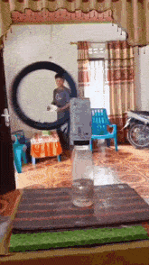 a bottle of water sits on a table in front of a man