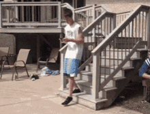 a man standing on a set of stairs wearing a number 58 shirt