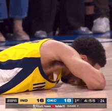 a basketball player laying on the floor during a game