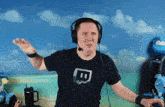 a man wearing headphones and a t-shirt with the letter t on it