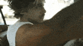 a man is sitting in the back seat of a car with his arms outstretched .