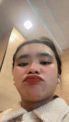 a woman making a funny face with her mouth wide open