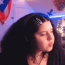 a woman wearing a headband with two hair clips on her hair