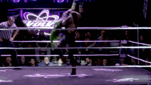 a wrestler in a ring with the word evolve on the back