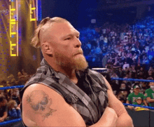 a man with a beard and a skull tattoo on his arm