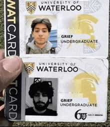 a person is holding two university of waterloo cards