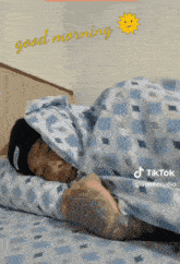 a man laying on a bed with a good morning message
