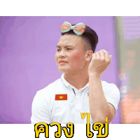a man wearing sunglasses and a bow tie is making a heart with his hand
