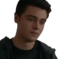 a close up of a young man 's face with a hoodie on