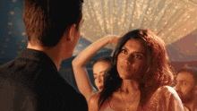 a man and a woman are looking at each other in a club