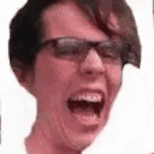 a close up of a person wearing sunglasses with their mouth open .