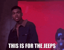 a man stands in front of a red wall with the words this is for the jeeps