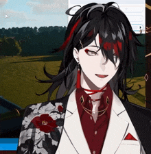 a man with long black hair is wearing a floral jacket and a red flower pin