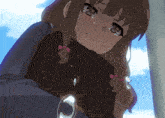 a girl with brown hair is crying while holding a brown briefcase