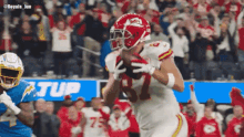 a football player in a red uniform with the number 81 on it