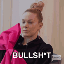 a woman is wearing a black hoodie with a pink bow and the word bullshit on the bottom
