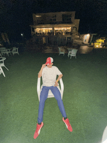 a person wearing a ny hat is sitting on a chair