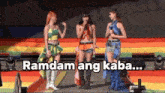 three women standing on a stage with the words " ramdam ang kaba " on the bottom
