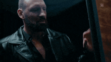 a man with a beard is standing in front of a sign that says wrestlemania