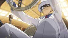 a man in a white suit and hat is holding a steering wheel