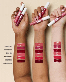 a woman 's arm is shown with different shades of lipstick