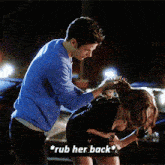 a man is rubbing a woman 's back with the words rub her back