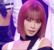 a woman with pink hair and a black choker