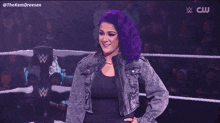 a woman is standing on a stage with a microphone in her hand .