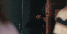 a man is looking at himself in a mirror while wearing a mask