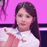 a girl wearing a headband with pearls on it looks at the camera