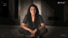 a woman in a black shirt is being recorded by netflix