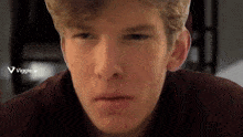 a close up of a man 's face with a viggle.ai logo in the background