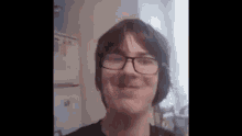 a close up of a person wearing glasses and headphones .