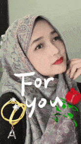 a woman wearing a hijab with the words for you written on the bottom