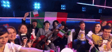 a group of people holding flags including one that says ' italy '