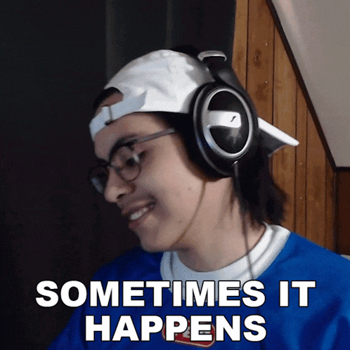 a man wearing headphones and a blue shirt says 