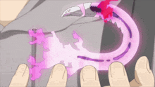 a person is holding a pink object that looks like a ring