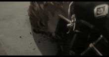 a close up of a person laying on the ground with a letter e on their chest
