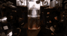 a man is laying in a glass container in a room