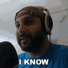 a man wearing headphones and a bandana says i know