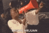 a woman is holding a megaphone in her mouth .