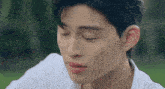 a close up of a young man 's face with his eyes closed and his mouth open .