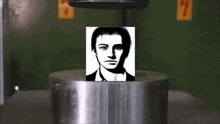 a drawing of a man 's face is on a metal cylinder