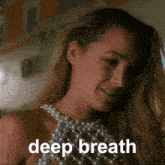 a woman wearing a pearl top with the words deep breath written below her