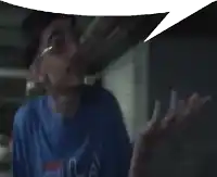 a man wearing a blue fila shirt with a speech bubble above his head