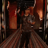 a man walking down a hallway holding a trophy that says ' a ' on it