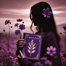 a woman holding a book that says coretan-putri on it