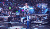 a woman in a wrestling ring holds up a sign that says " i 'm turning can i get with you "