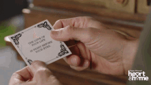 a person is holding a piece of paper that says the love of your life is right before your eyes